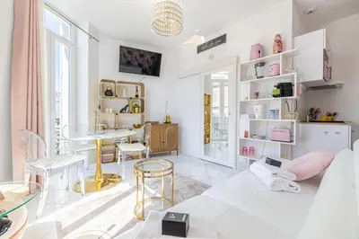 a white living room with a table and chairs at VIP - Lovely studio for 2 people 5 minutes from Palais des Festivals in Cannes