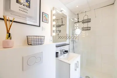 a white bathroom with a sink and a shower at VIP - Lovely studio for 2 people 5 minutes from Palais des Festivals in Cannes