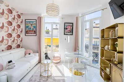 a living room with a white couch and a table at VIP - Lovely studio for 2 people 5 minutes from Palais des Festivals in Cannes