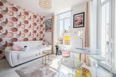 a living room with a white couch and a table at VIP - Lovely studio for 2 people 5 minutes from Palais des Festivals in Cannes