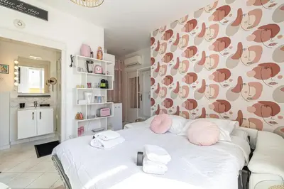 a bedroom with a bed with pink towels on it at VIP - Lovely studio for 2 people 5 minutes from Palais des Festivals in Cannes
