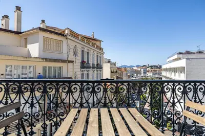 a wooden bench sitting on top of a balcony at VIP - Lovely studio for 2 people 5 minutes from Palais des Festivals in Cannes