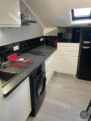 a kitchen with a washing machine and a sink at Studio Cannes banane in Cannes
