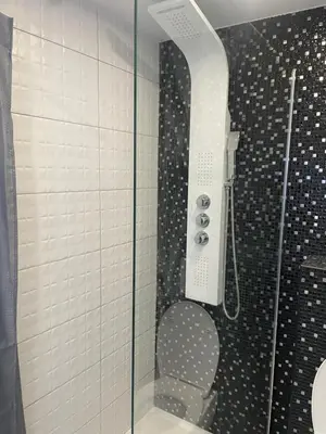 a shower with a glass door in a bathroom at Studio Cannes banane in Cannes