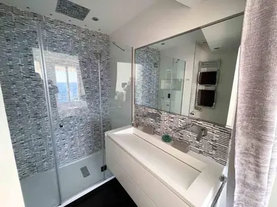 a bathroom with a sink and a large mirror at Stunning 2 bedroom flat with sea view on Croisette in Cannes