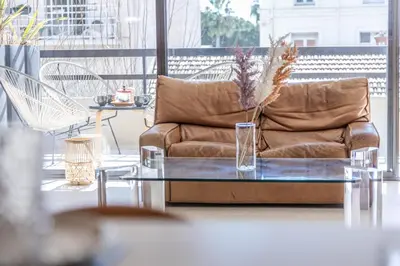 a living room with a couch and a table at LB Vacation Rentals I A short Stroll to Palais, Beach, Terrace & Seaview in Cannes