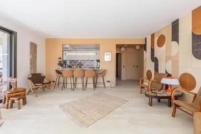 a living room with chairs and a table at LB Vacation Rentals I A short Stroll to Palais, Beach, Terrace & Seaview in Cannes