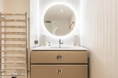 a bathroom with a sink and a mirror at LB Vacation Rentals I A short Stroll to Palais, Beach, Terrace & Seaview in Cannes