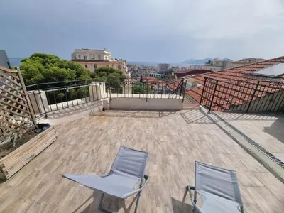 a pair of chairs sitting on top of a roof at Appartement Grasse Toit Terrasse in Cannes