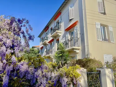 a building with purple flowers in front of it at Fiorella's Cannes Oasis in Cannes