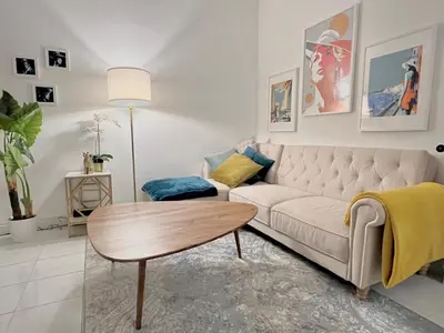 a living room with a white couch and a table at Fiorella's Cannes Oasis in Cannes