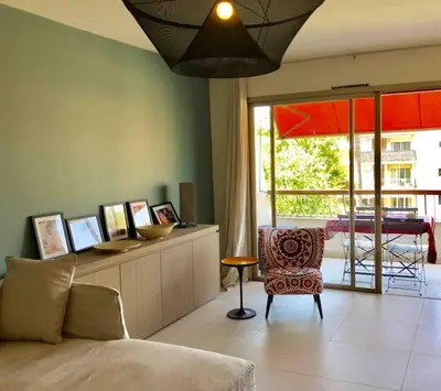 a living room with a couch and a chair at Superbe Appartement Cannes - 50m2 & Terrasse - Très Proche Croisette in Cannes