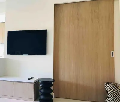 a wooden door with a television on a wall at Superbe Appartement Cannes - 50m2 & Terrasse - Très Proche Croisette in Cannes