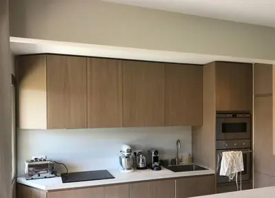 a kitchen with wooden cabinets and a counter top at Superbe Appartement Cannes - 50m2 & Terrasse - Très Proche Croisette in Cannes