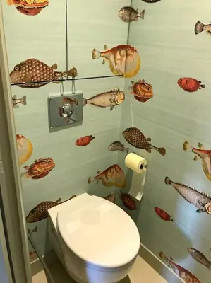 a bathroom with a toilet with fish on the wall at Superbe Appartement Cannes - 50m2 & Terrasse - Très Proche Croisette in Cannes