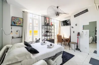 a bedroom with a bed and a dining room at PRIVATE - Small studio for two at 5 minutes from Croisette in Cannes