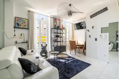a living room with a white couch and a table at PRIVATE - Small studio for two at 5 minutes from Croisette in Cannes