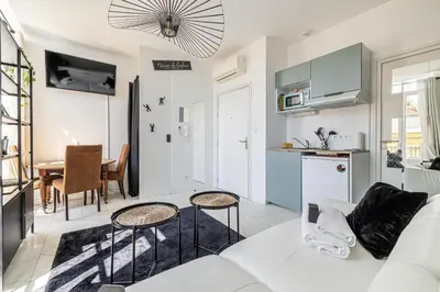 a living room with a couch and a table at PRIVATE - Small studio for two at 5 minutes from Croisette in Cannes