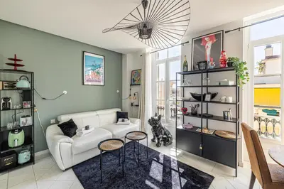 a living room with a white couch and a table at PRIVATE - Small studio for two at 5 minutes from Croisette in Cannes