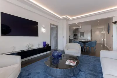 a living room with a couch and a table at Palais Des Iles - La Croisette by Halldis in Cannes