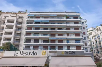 a large white building with a sign in front of it at Palais Des Iles - La Croisette by Halldis in Cannes