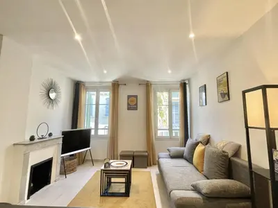 a living room with a couch and a fireplace at Greyson apartment 3 from Palais by Welcome to Cannes in Cannes
