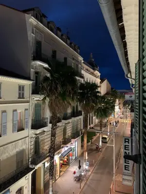 a city street with palm trees and a building at Greyson apartment 3 from Palais by Welcome to Cannes in Cannes