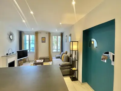 a living room with a blue accent wall at Greyson apartment 3 from Palais by Welcome to Cannes in Cannes