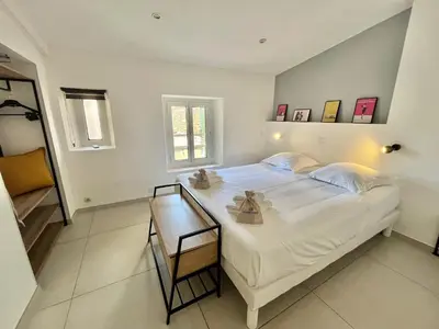 a bedroom with a large white bed and a window at Greyson apartment 3 from Palais by Welcome to Cannes in Cannes