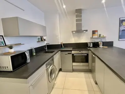 a kitchen with a microwave and a dishwasher at Greyson apartment 3 from Palais by Welcome to Cannes in Cannes