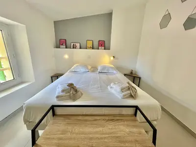a bedroom with a bed with white sheets and a window at Greyson apartment 3 from Palais by Welcome to Cannes in Cannes