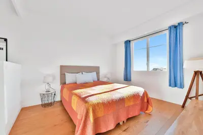 a bedroom with a bed and a large window at LE MARINE vue mer avec joli terrasse, un rêve pour les couples in Cannes
