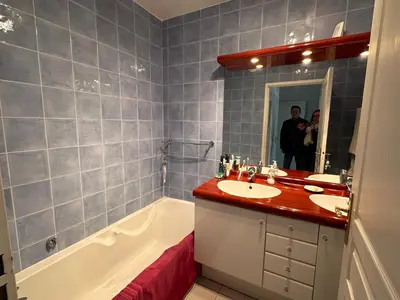 a man taking a picture of a bathroom with a tub and sink at 2 bedroom apartment with a pool in the heart of Cannes easy walk to the main beach on La Croisette - 2191 in Cannes