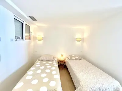 two beds in a small room with two lamps at Shelly luxury sea view by Welcome to Cannes in Cannes