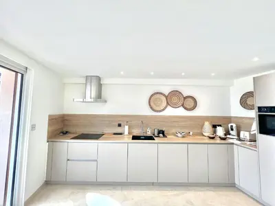 a kitchen with white cabinets and a sink at Shelly luxury sea view by Welcome to Cannes in Cannes
