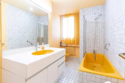 a bathroom with a yellow tub and a sink at Selvosa 1-bedroom apartment heart of Cannes in Cannes