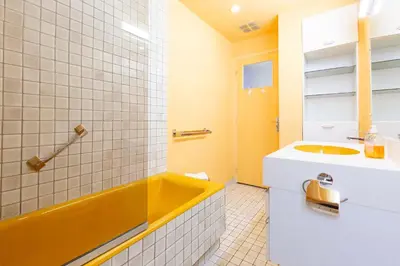 a bathroom with a yellow tub and a sink at Selvosa 1-bedroom apartment heart of Cannes in Cannes