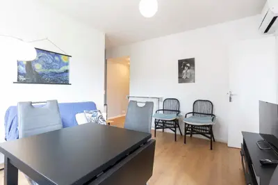 a living room with a table and chairs at Selvosa 1-bedroom apartment heart of Cannes in Cannes