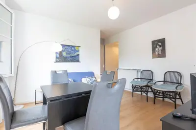 a living room with a table and chairs at Selvosa 1-bedroom apartment heart of Cannes in Cannes