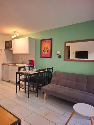 a living room with a couch and a table at Appartement 3 pièces piscine proche plage et Cannes in Cannes