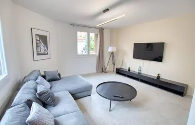 a living room with a blue couch and a table at Maison Moderne Cannes 3 Chambres 3 Salles de Bain WIFI - LIMESTAY in Cannes