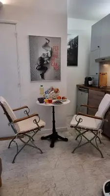 a kitchen with two chairs and a table in a room at Cannes Studio privé climatisé et bon wifi in Cannes