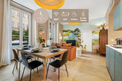 a kitchen and living room with a table and chairs at L'Urban - 3 chambres - 9 min Palais - Climatisé in Cannes