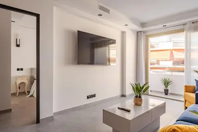 a living room with a couch and a tv at Plage luxe collé à l’hôtel Martinez in Cannes