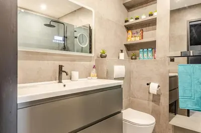 a bathroom with a sink and a toilet and a mirror at Plage luxe collé à l’hôtel Martinez in Cannes