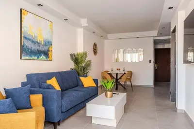 a living room with a blue couch and a table at Plage luxe collé à l’hôtel Martinez in Cannes
