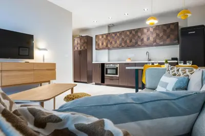 a living room with a couch and a kitchen at Downtown Cannes Apartment with Garden in Cannes