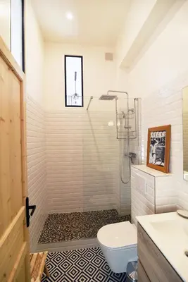 a bathroom with a shower with a toilet and a sink at Charming studio very central and calm in Cannes