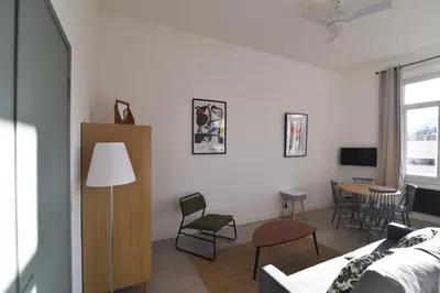 a living room with a couch and a table at Charming studio very central and calm in Cannes