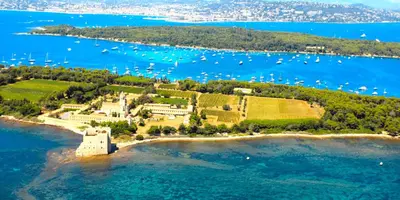 an island in the ocean with boats in the water at Charming studio very central and calm in Cannes
